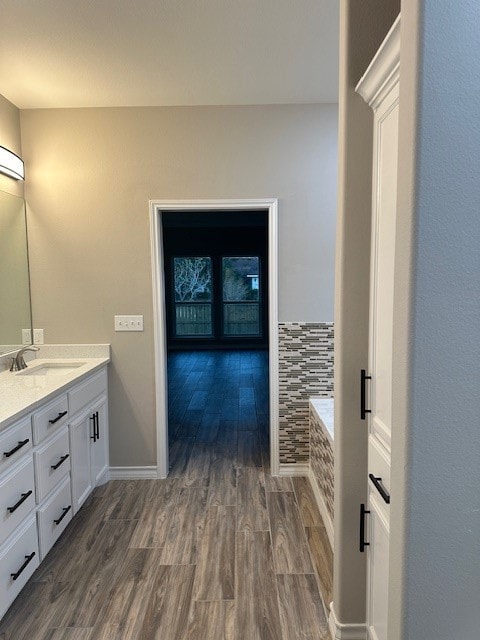 bathroom featuring vanity, a bathtub, and wood-type flooring