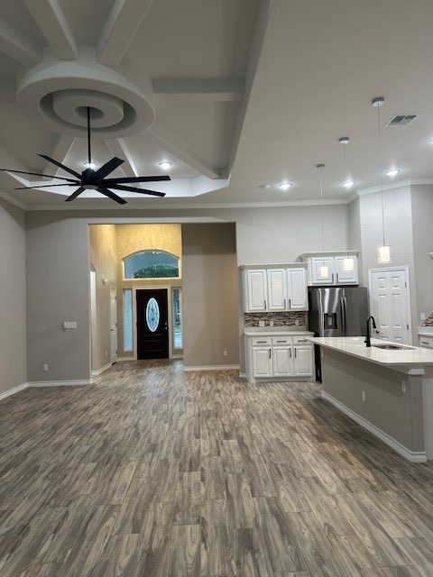 interior space featuring crown molding, dark hardwood / wood-style flooring, ceiling fan, and sink