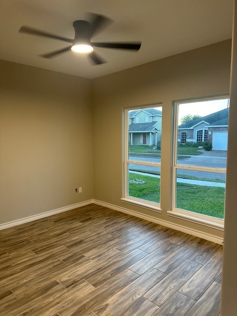 unfurnished room featuring hardwood / wood-style floors and ceiling fan