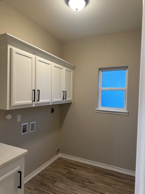 clothes washing area featuring electric dryer hookup, hookup for a washing machine, cabinets, and dark hardwood / wood-style floors