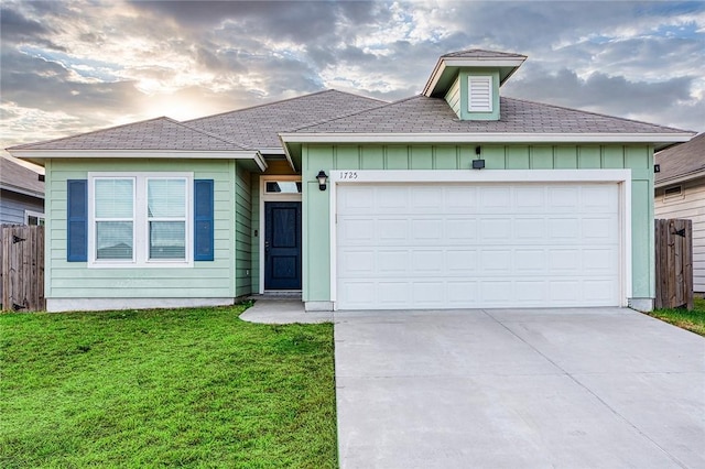 single story home with driveway, a front lawn, board and batten siding, and an attached garage