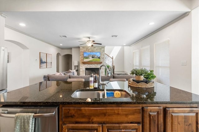 1805 Bay Landing Dr, Portland, TX 78374 - kitchen featuring dishwasher, a ceiling fan, open floor plan, arched walkways, and dark stone countertops
