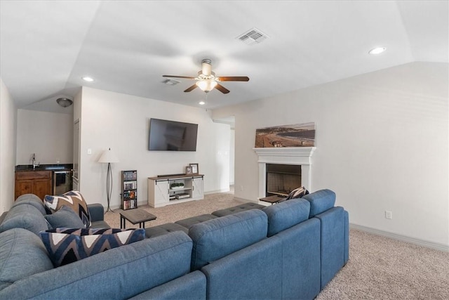 1805 Bay Landing Dr, Portland, TX 78374 - carpeted living room with a ceiling fan, recessed lighting, a fireplace with raised hearth, vaulted ceiling, and bar area