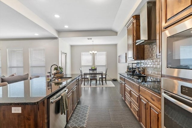 1805 Bay Landing Dr, Portland, TX 78374 - kitchen with stainless steel appliances, wall chimney exhaust hood, decorative backsplash, recessed lighting, and a chandelier