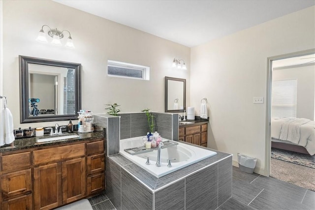 1805 Bay Landing Dr, Portland, TX 78374 - ensuite bathroom with two vanities, a garden tub, and tile patterned floors