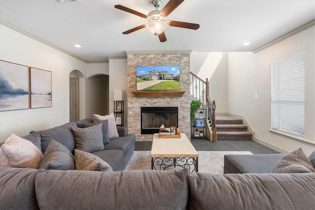 1805 Bay Landing Dr, Portland, TX 78374 - living room featuring crown molding, a ceiling fan, arched walkways, stairs, and a fireplace