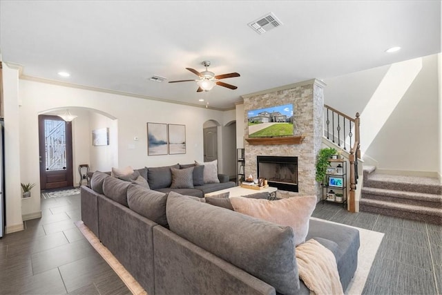 1805 Bay Landing Dr, Portland, TX 78374 - living room with arched walkways, a fireplace, stairway, ceiling fan, and recessed lighting