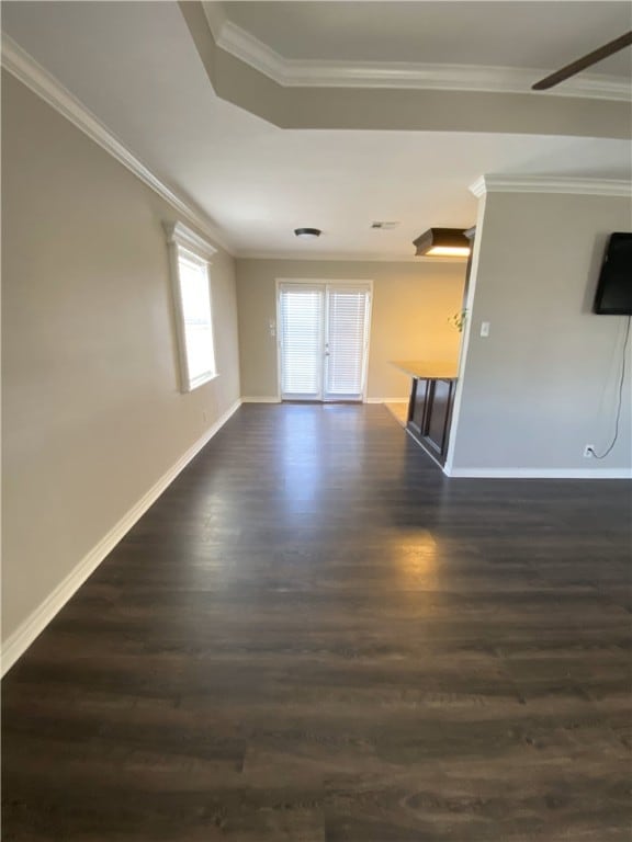 unfurnished room with ornamental molding and dark wood-type flooring