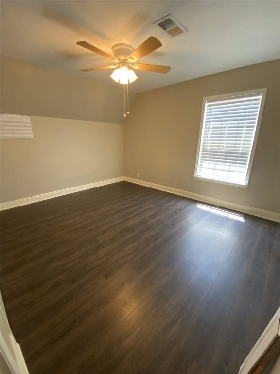 1038 Dorthy Dr, Corpus Christi, TX 78412 - unfurnished room featuring dark wood-style flooring, ceiling fan, and lofted ceiling