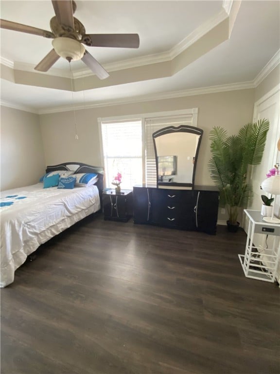 bedroom featuring ornamental molding, a raised ceiling, ceiling fan, and dark wood-type flooring