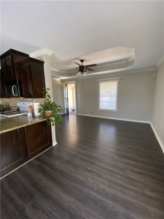 1038 Dorthy Dr, Corpus Christi, TX 78412 - kitchen with ornamental molding, stainless steel microwave, white electric range oven, a tray ceiling, and dark wood-type flooring
