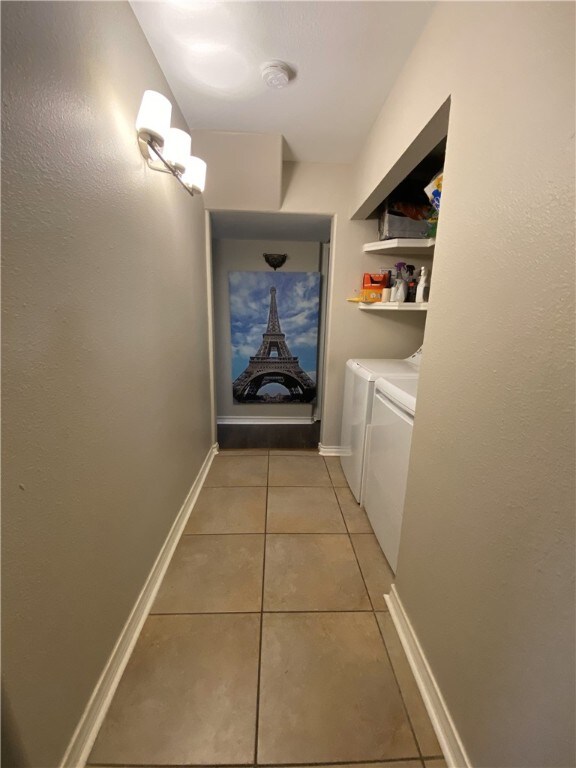 washroom with tile patterned floors and washer and dryer