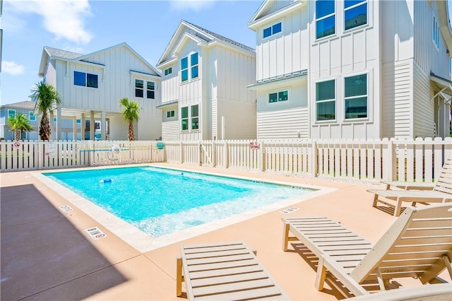 pool with a patio and fence