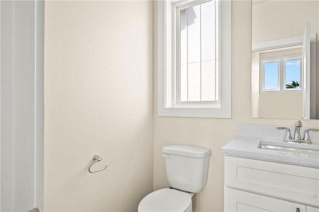 bathroom with toilet and vanity