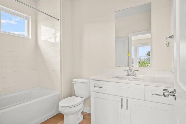 full bath featuring shower / bath combination, plenty of natural light, toilet, and vanity