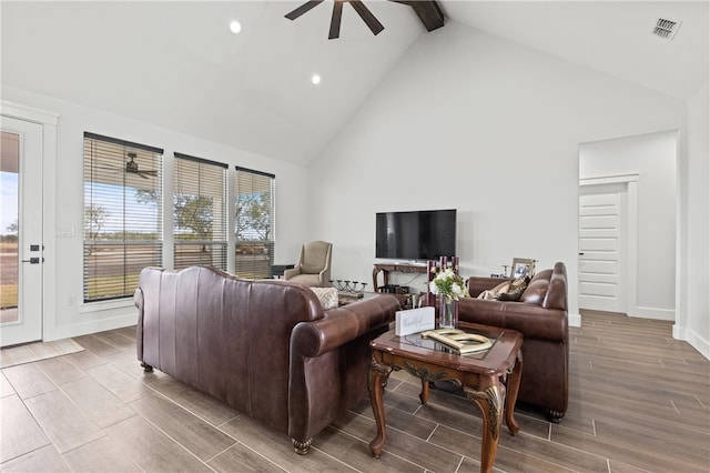 living room with beamed ceiling, hardwood / wood-style flooring, high vaulted ceiling, and ceiling fan