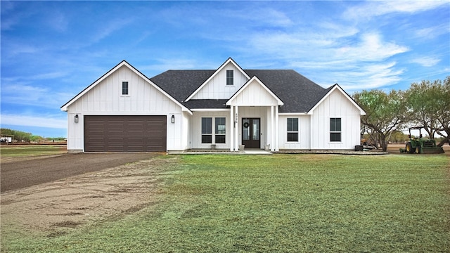 modern farmhouse style home with a front lawn and a garage