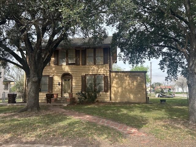 colonial-style house with a front yard