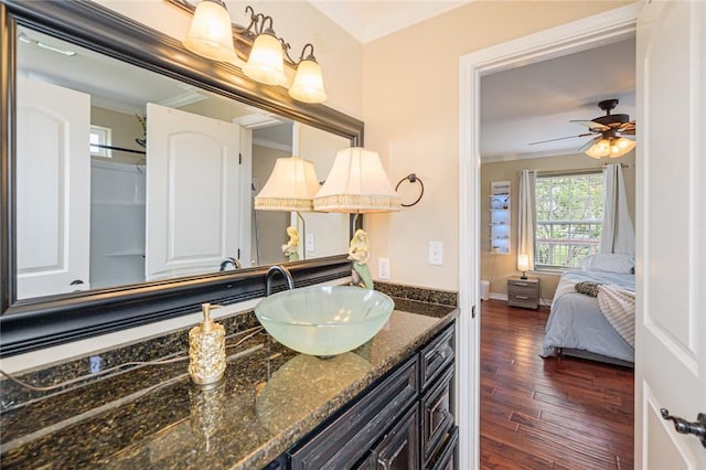 123 Bishop Rd, Rockport, TX 78382 - ensuite bathroom with crown molding, wood finished floors, vanity, and ceiling fan