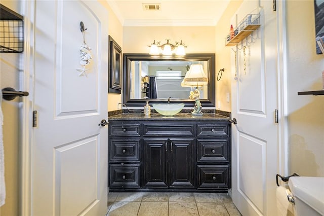 123 Bishop Rd, Rockport, TX 78382 - bathroom with toilet, vanity, crown molding, and tile patterned floors