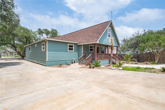 123 Bishop Rd, Rockport, TX 78382 - view of front of home featuring concrete driveway, a porch, and a shingled roof