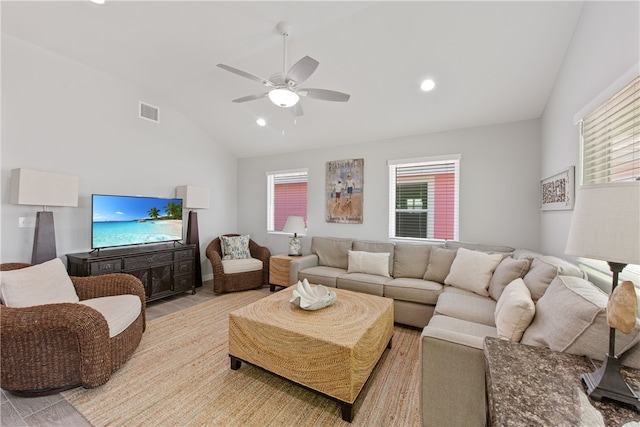 living room with light wood-type flooring, vaulted ceiling, and ceiling fan