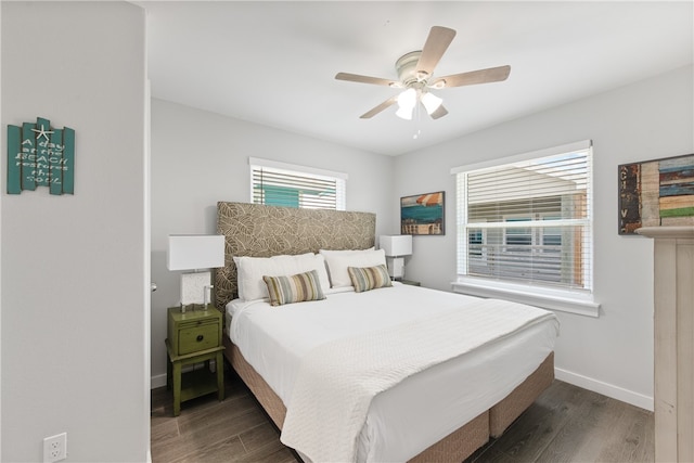 bedroom with ceiling fan and dark hardwood / wood-style floors