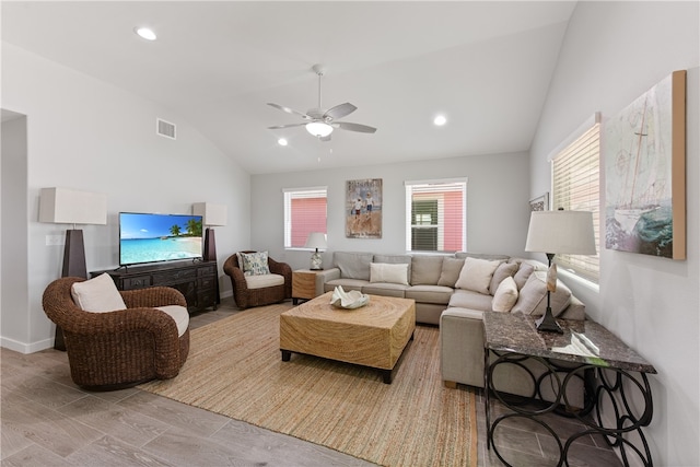 living room with vaulted ceiling, ceiling fan, and light hardwood / wood-style flooring