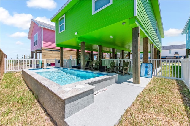 view of swimming pool featuring a lawn and a patio