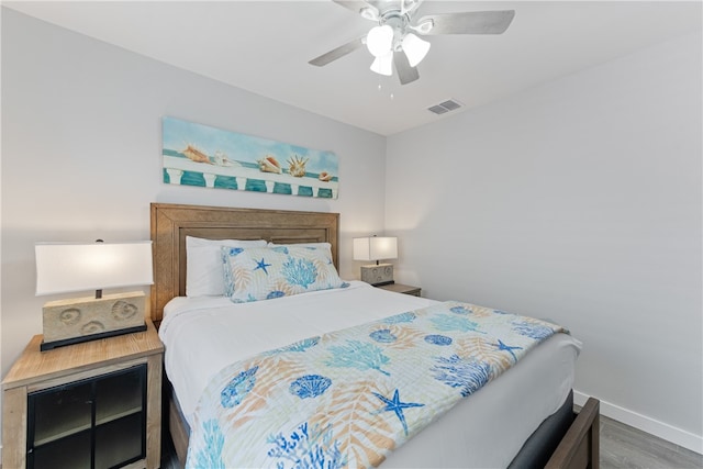 bedroom with hardwood / wood-style floors and ceiling fan