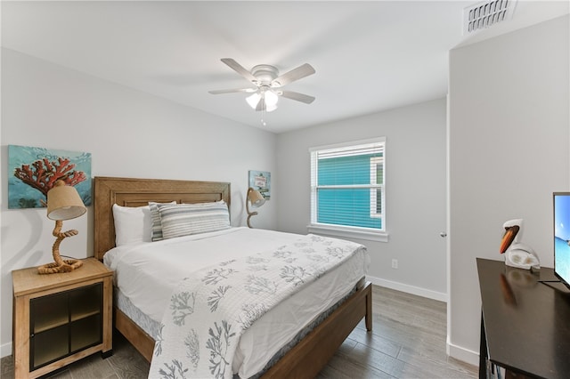 bedroom featuring hardwood / wood-style flooring and ceiling fan