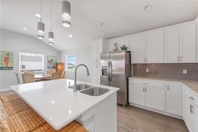 kitchen featuring white cabinetry, sink, and stainless steel fridge with ice dispenser