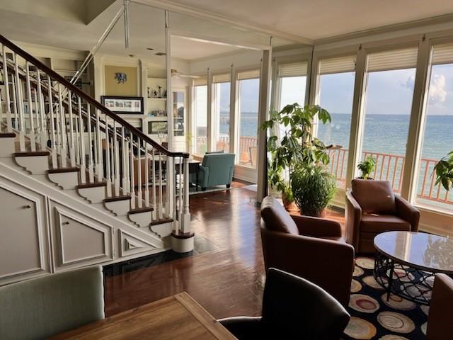4454 Ocean Dr Unit 4, Corpus Christi, TX 78412 - staircase featuring a water view, wood finished floors, and crown molding