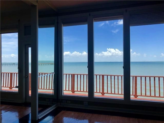 4454 Ocean Dr Unit 4, Corpus Christi, TX 78412 - unfurnished sunroom featuring a water view and wood finished floors