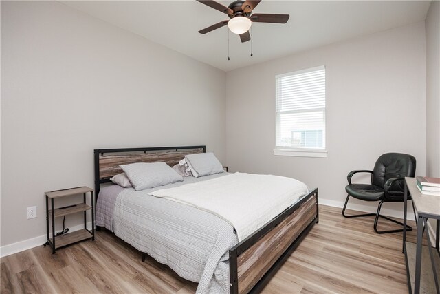 bedroom with light hardwood / wood-style flooring and ceiling fan