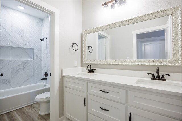 full bathroom featuring toilet, vanity, hardwood / wood-style floors, and  shower combination