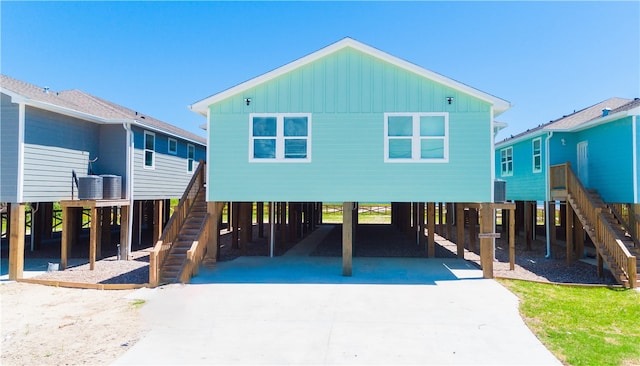 view of front of property with central AC and a carport