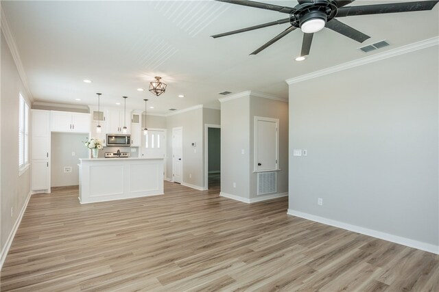 unfurnished living room featuring ornamental molding, light wood-type flooring, and ceiling fan