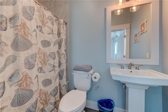 full bathroom with toilet, curtained shower, and a sink