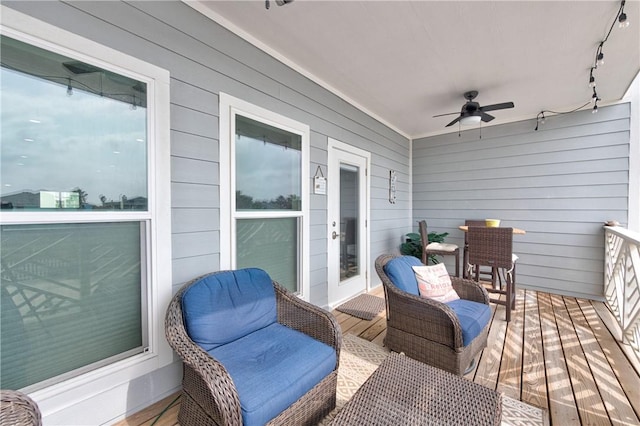 wooden terrace featuring a ceiling fan