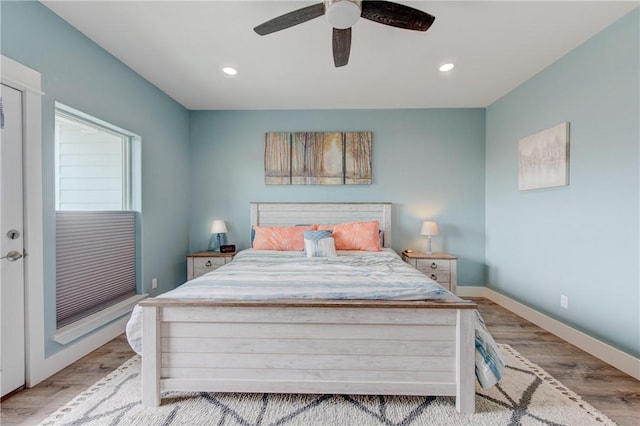 bedroom featuring baseboards, ceiling fan, wood finished floors, and recessed lighting