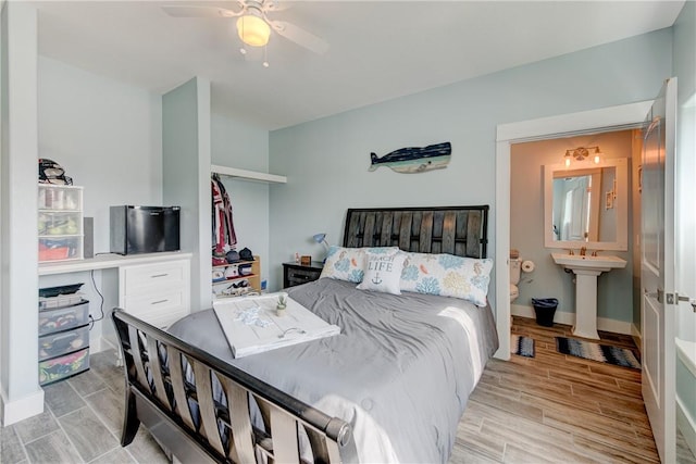 bedroom with baseboards, a ceiling fan, and wood tiled floor