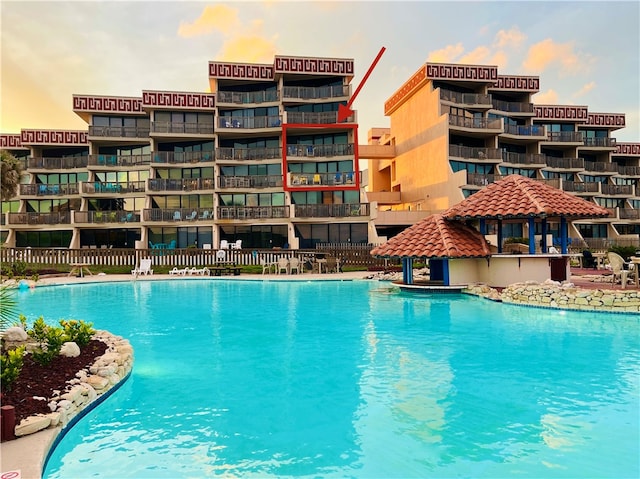 view of pool at dusk