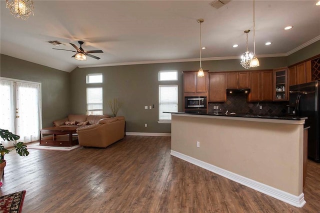 kitchen featuring black refrigerator with ice dispenser, plenty of natural light, dark hardwood / wood-style flooring, and pendant lighting