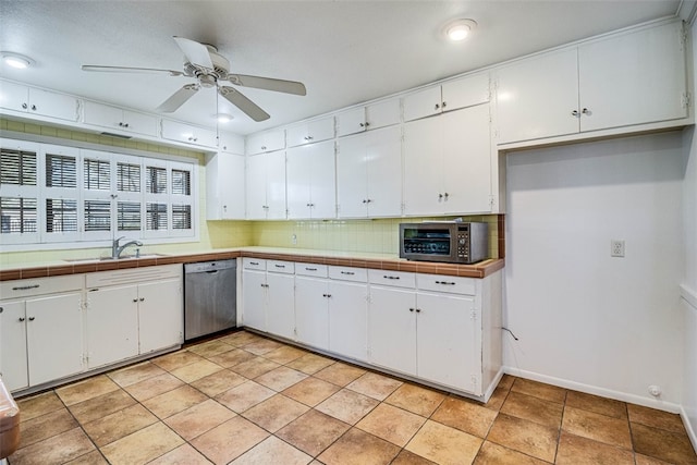 kitchen featuring decorative backsplash, dishwasher, ceiling fan, white cabinetry, and a sink