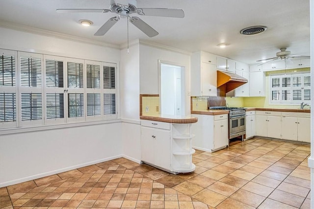 kitchen with range with two ovens, under cabinet range hood, visible vents, white cabinets, and crown molding