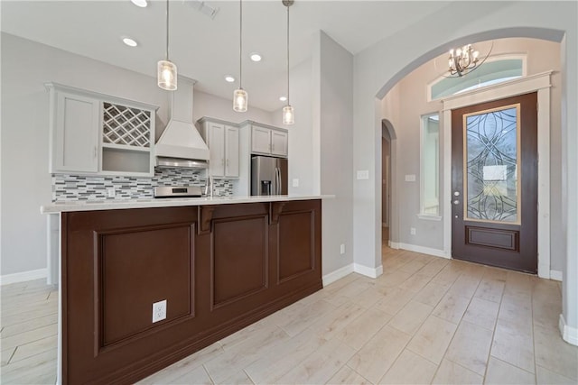 1706 Kentucky Derby Dr, Corpus Christi, TX 78417 - kitchen with light countertops, stainless steel appliances, backsplash, and custom range hood