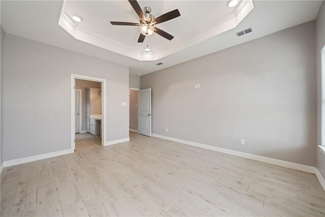 1706 Kentucky Derby Dr, Corpus Christi, TX 78417 - unfurnished bedroom with a tray ceiling, crown molding, light wood-type flooring, baseboards, and visible vents