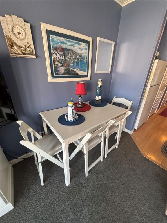 3938 Surfside Blvd Unit 2235, Corpus Christi, TX 78402 - carpeted dining space featuring baseboards
