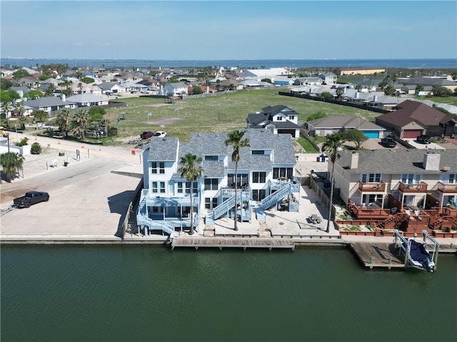 drone / aerial view featuring a water view and a residential view